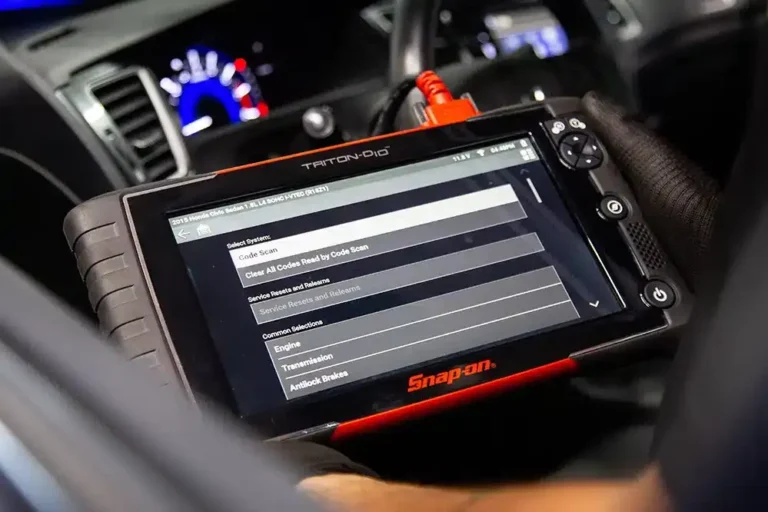 Mechanic Checking Error Codes Using Scanner