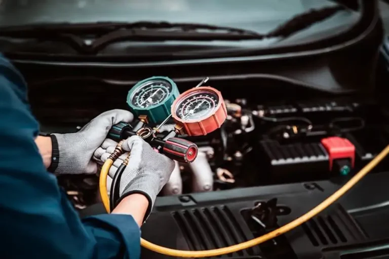 Mechanic Checking Presure Of AC Car